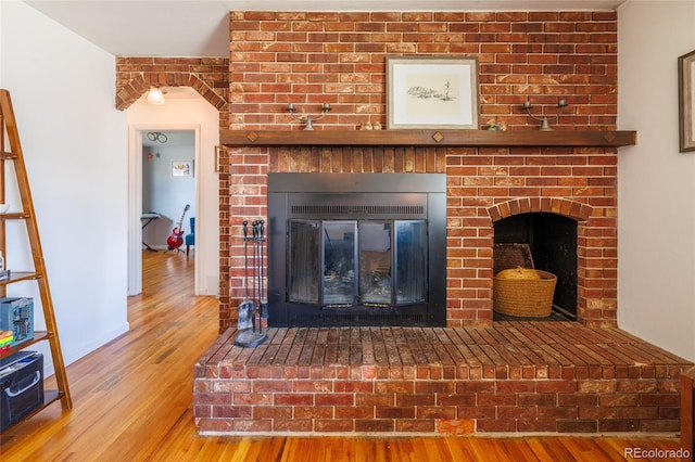 interior details featuring a fireplace and wood finished floors