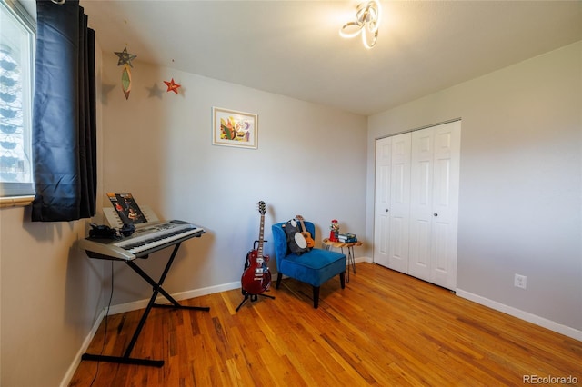 sitting room featuring light wood-style floors and baseboards