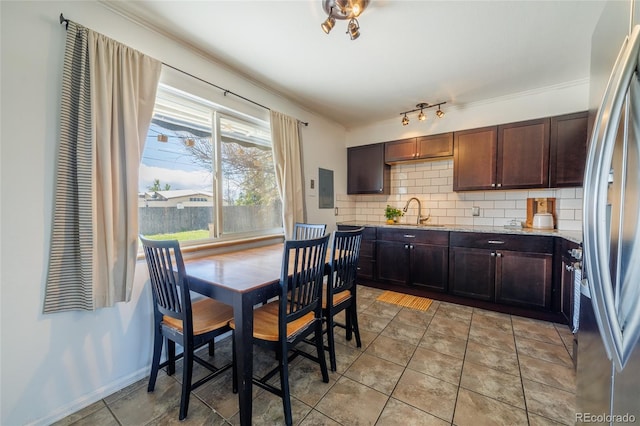 dining space with crown molding and electric panel