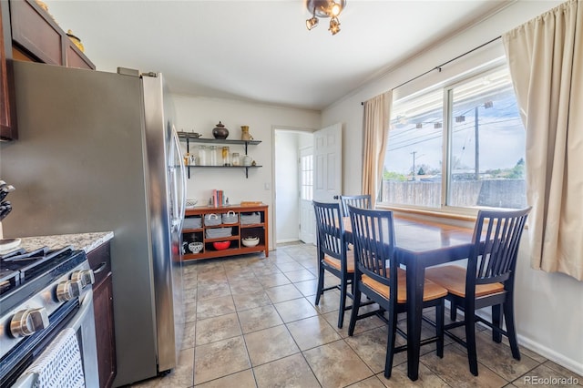 dining area with crown molding and baseboards