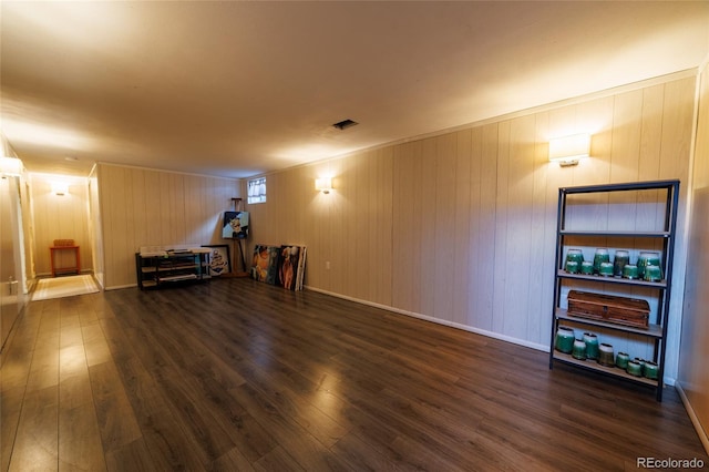 interior space featuring wood finished floors and wooden walls