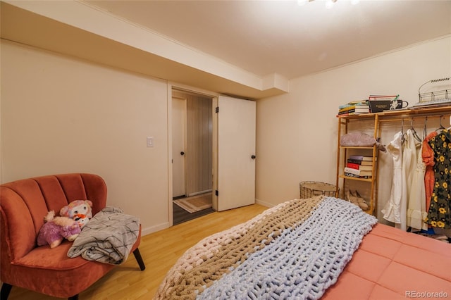 bedroom featuring baseboards and light wood-style flooring