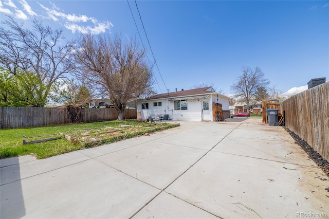 back of property with a patio area, fence, and driveway