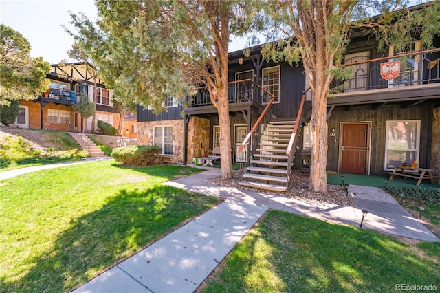 exterior space with a lawn and stairway