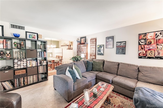 living room featuring carpet floors, a chandelier, and visible vents