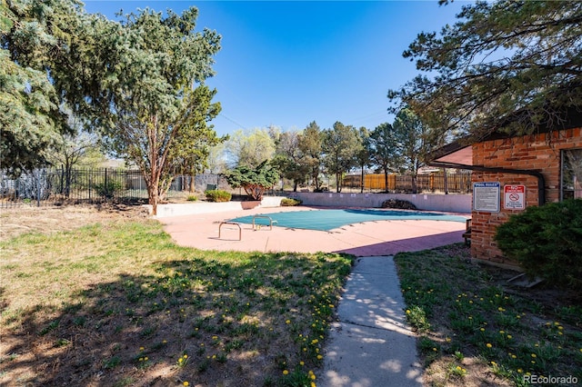 community pool featuring a fenced backyard