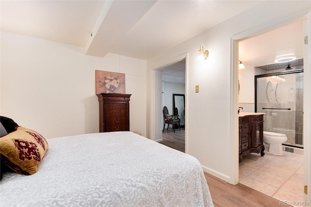 5215 S Washington St, Littleton, CO 80121 - bedroom with light wood-style floors and ensuite bath