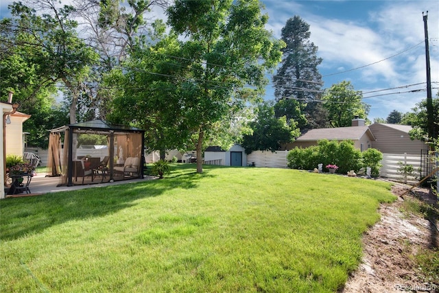 5215 S Washington St, Littleton, CO 80121 - view of grassy yard with a gazebo, a storage shed, and a patio area