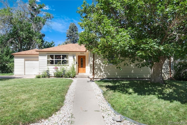 5215 S Washington St, Littleton, CO 80121 - view of front of house with a front lawn and an attached garage