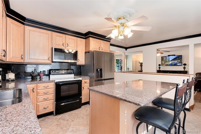 5215 S Washington St, Littleton, CO 80121 - kitchen featuring appliances with stainless steel finishes, ceiling fan, crown molding, a kitchen breakfast bar, and light brown cabinets