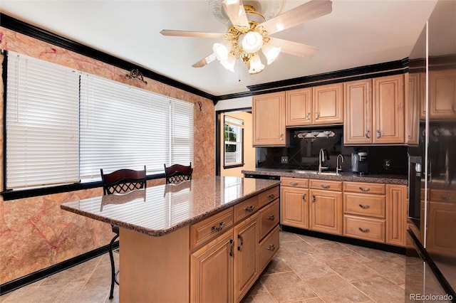 5215 S Washington St, Littleton, CO 80121 - kitchen featuring a breakfast bar area, a ceiling fan, crown molding, stone counters, and decorative backsplash