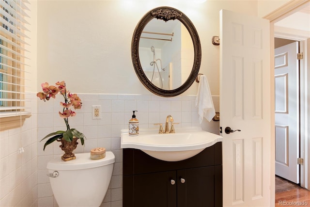 5215 S Washington St, Littleton, CO 80121 - bathroom with vanity, a wainscoted wall, and tile walls