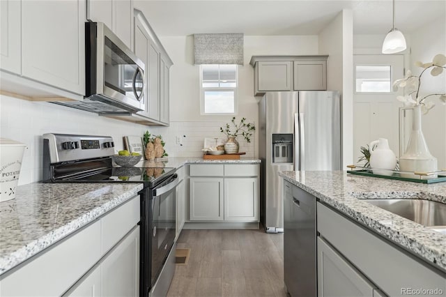 1388 S Boston Ct Unit B, Denver, CO 80247 - kitchen with stainless steel appliances, healthy amount of natural light, gray cabinetry, and backsplash