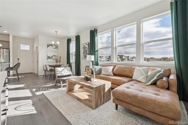 1388 S Boston Ct Unit B, Denver, CO 80247 - living area featuring a chandelier, wood finished floors, and recessed lighting