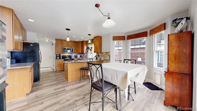 dining space with light hardwood / wood-style flooring