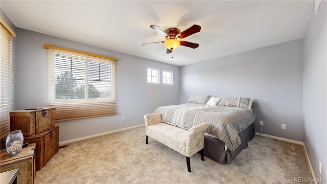 bedroom with light carpet and ceiling fan