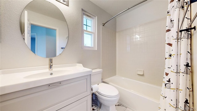 full bathroom featuring shower / bathtub combination with curtain, vanity, and toilet