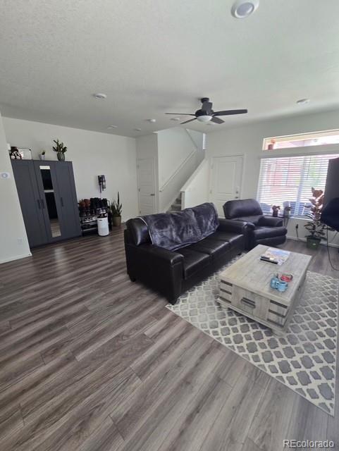 18006 E 103rd Ave, Commerce City, CO 80022 - living room featuring wood finished floors, stairway, and ceiling fan