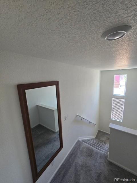 18006 E 103rd Ave, Commerce City, CO 80022 - hall with carpet floors, a textured ceiling, and baseboards