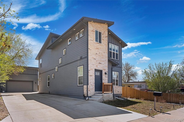 5470 Krameria St, Commerce City, CO 80022 - view of home's exterior with stone siding, a garage, fence, concrete driveway, and board and batten siding