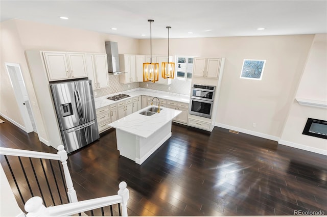 5470 Krameria St, Commerce City, CO 80022 - kitchen featuring stainless steel appliances, a sink, wall chimney exhaust hood, decorative backsplash, and baseboards
