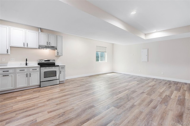 5470 Krameria St, Commerce City, CO 80022 - kitchen featuring stainless steel electric stove, under cabinet range hood, light countertops, light wood finished floors, and recessed lighting