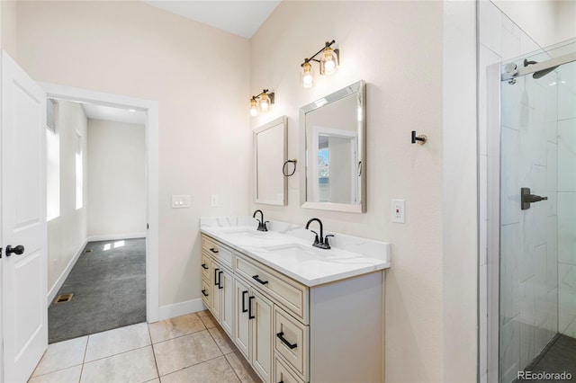 5470 Krameria St, Commerce City, CO 80022 - bathroom with a tile shower, double vanity, tile patterned flooring, and baseboards