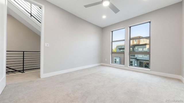 unfurnished room with ceiling fan, light carpet, and lofted ceiling