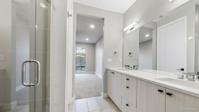 bathroom with vanity, an enclosed shower, and tile patterned flooring