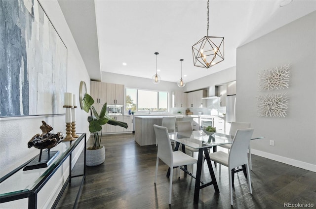 dining room with dark wood-type flooring and an inviting chandelier