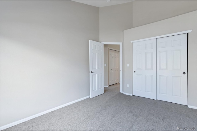 unfurnished bedroom featuring carpet floors and a closet