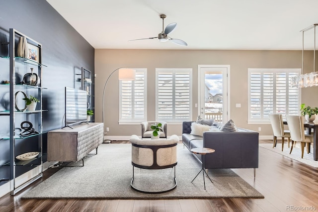 268 Simmental Loop, Castle Rock, CO 80104 - living area with a ceiling fan, wood finished floors, and a chandelier