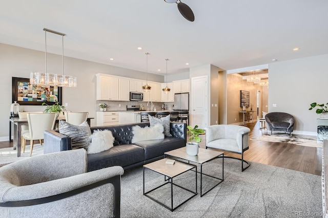 268 Simmental Loop, Castle Rock, CO 80104 - living room with a chandelier, wood finished floors, and recessed lighting
