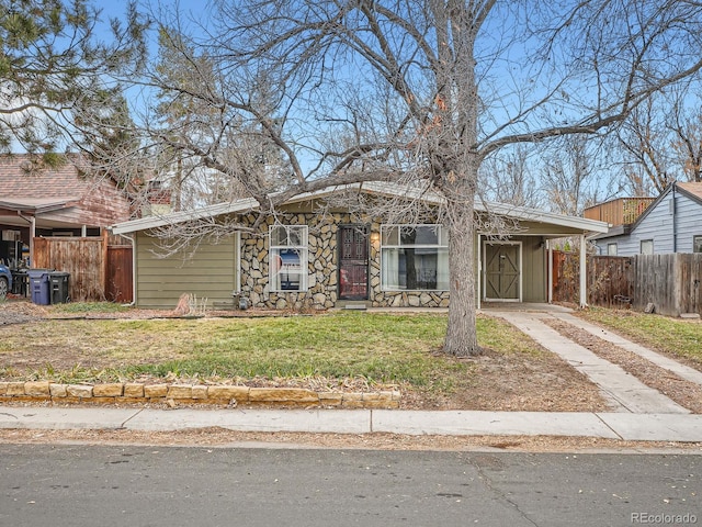 view of front facade featuring a front lawn and a carport