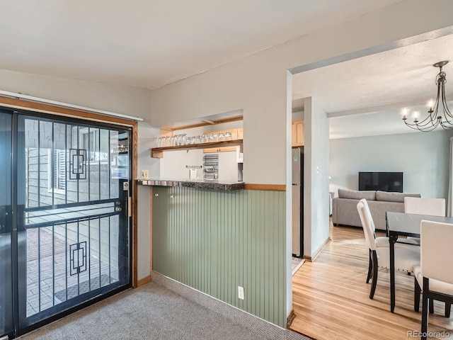 interior space featuring a chandelier and light hardwood / wood-style floors