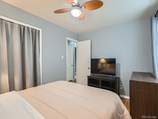 bedroom with ceiling fan and hardwood / wood-style floors