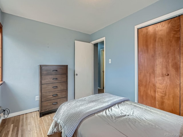 bedroom featuring light hardwood / wood-style floors and a closet