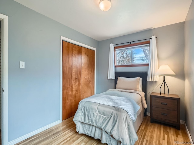 bedroom featuring light hardwood / wood-style floors and a closet