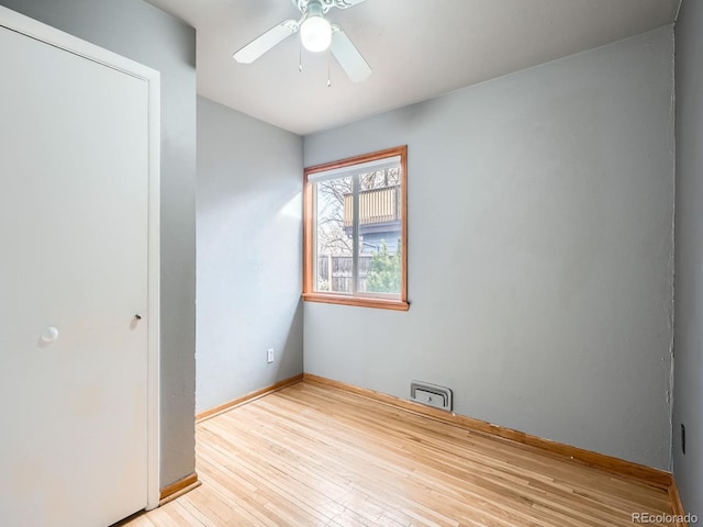 empty room featuring ceiling fan and light wood-type flooring