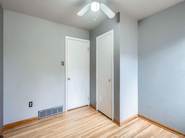 unfurnished bedroom featuring a closet, ceiling fan, and light wood-type flooring