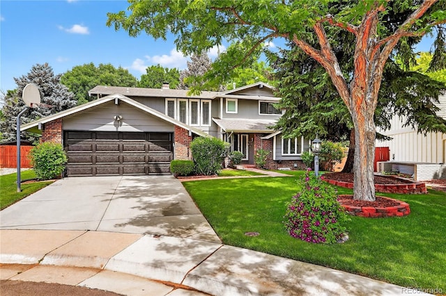 6338 S Oneida Ct, Centennial, CO 80111 - view of front of house featuring an attached garage, brick siding, concrete driveway, and a chimney