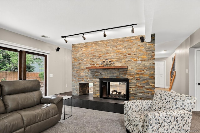 6338 S Oneida Ct, Centennial, CO 80111 - living room with carpet, track lighting, and a stone fireplace