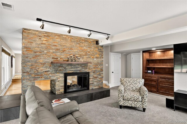 6338 S Oneida Ct, Centennial, CO 80111 - living room featuring track lighting and a stone fireplace