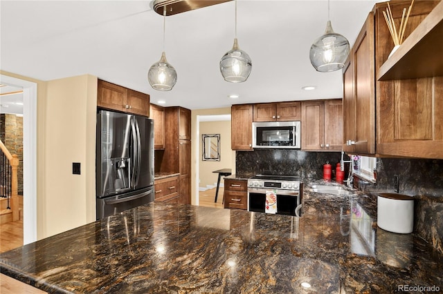 6338 S Oneida Ct, Centennial, CO 80111 - kitchen featuring appliances with stainless steel finishes, tasteful backsplash, a peninsula, pendant lighting, and recessed lighting