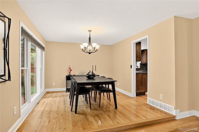 6338 S Oneida Ct, Centennial, CO 80111 - dining space with light wood-style floors and a chandelier