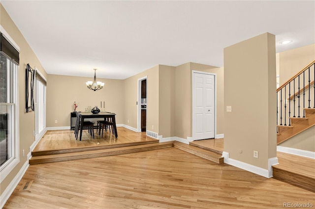 6338 S Oneida Ct, Centennial, CO 80111 - dining space featuring light wood-style floors, a chandelier, and stairs