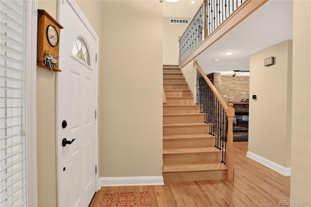 6338 S Oneida Ct, Centennial, CO 80111 - entrance foyer featuring wood finished floors, stairs, and a towering ceiling