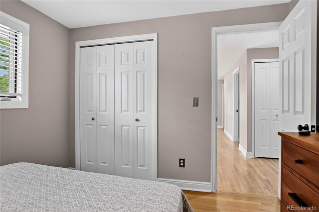 6338 S Oneida Ct, Centennial, CO 80111 - bedroom with light wood-style flooring and a closet