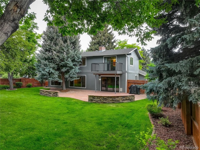 6338 S Oneida Ct, Centennial, CO 80111 - back of property with a balcony, a patio, a fenced backyard, and a chimney