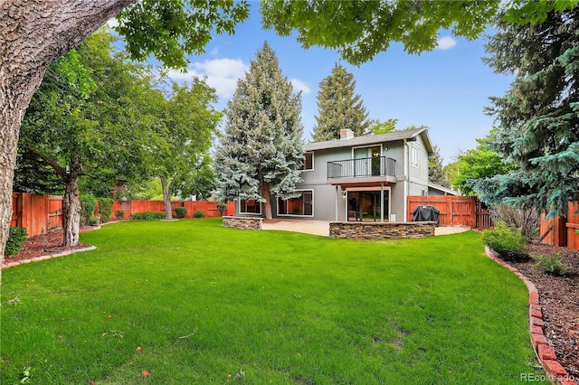 6338 S Oneida Ct, Centennial, CO 80111 - rear view of property featuring a balcony, a fenced backyard, a chimney, and a patio